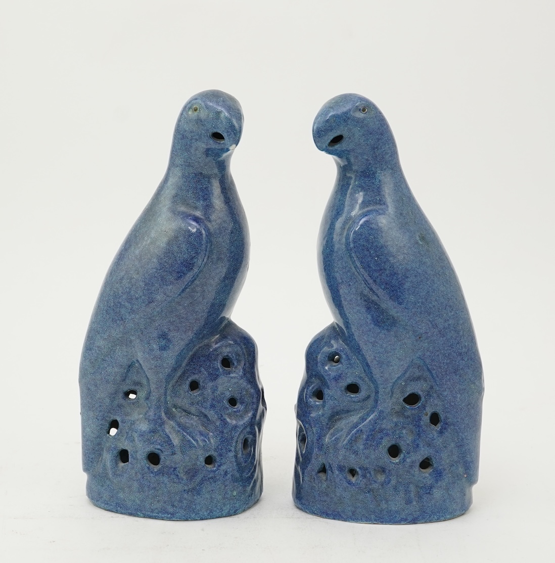 A pair of Chinese blue mottle glazed models of parakeets, 19th century
